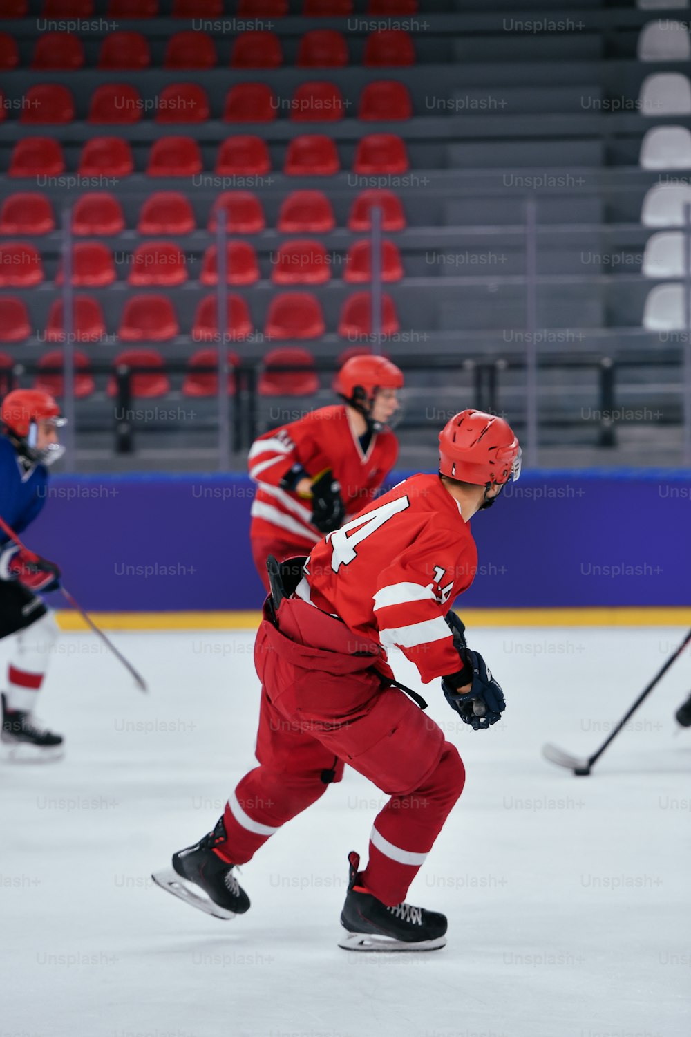 a group of young men playing a game of ice hockey