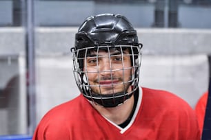 a man in a red hockey uniform with a helmet on