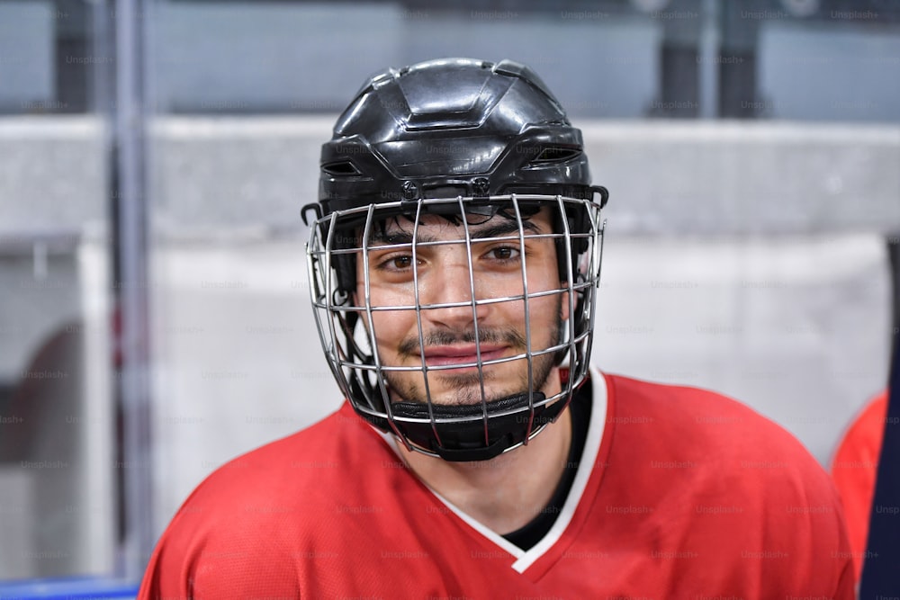 a man in a red hockey uniform with a helmet on