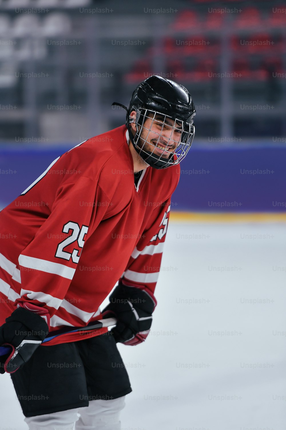 a hockey player in a red jersey on the ice