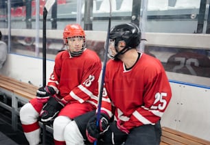 a couple of men sitting on top of a bench