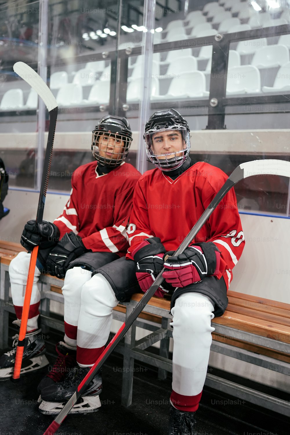 a couple of men sitting on top of a bench