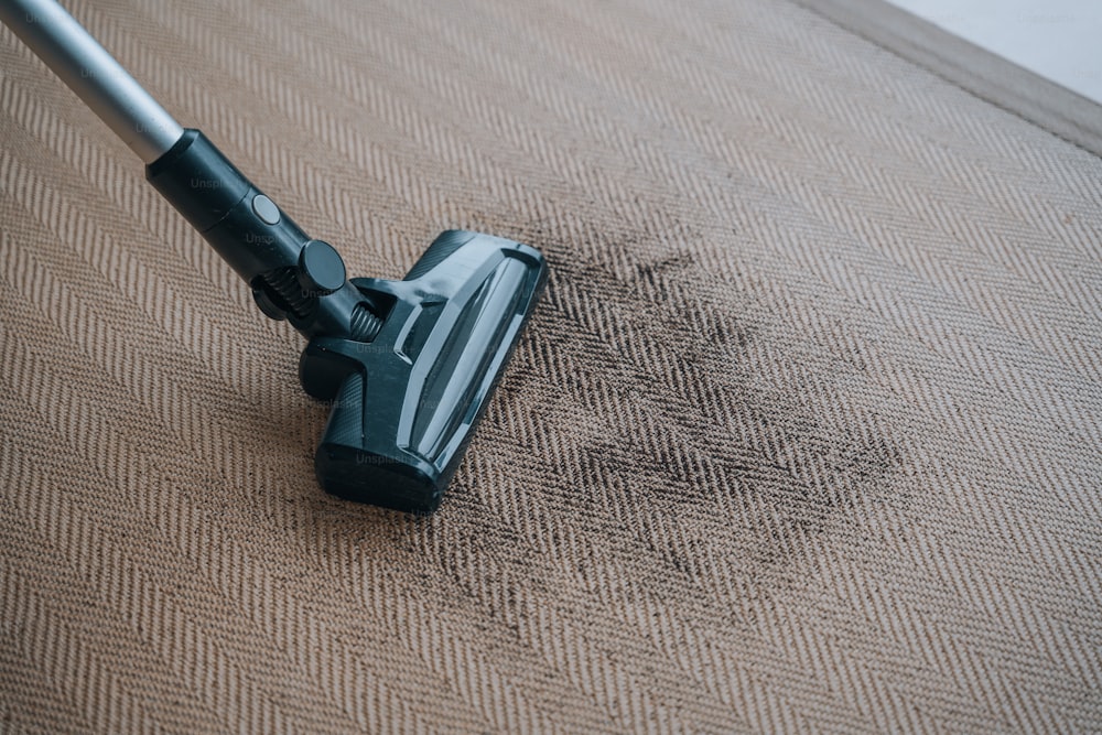 a close up of a vacuum on a carpet