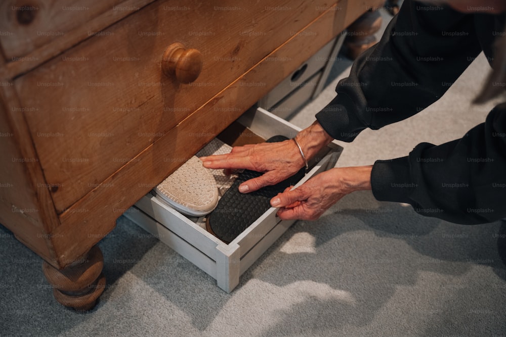 a person is reaching into a drawer