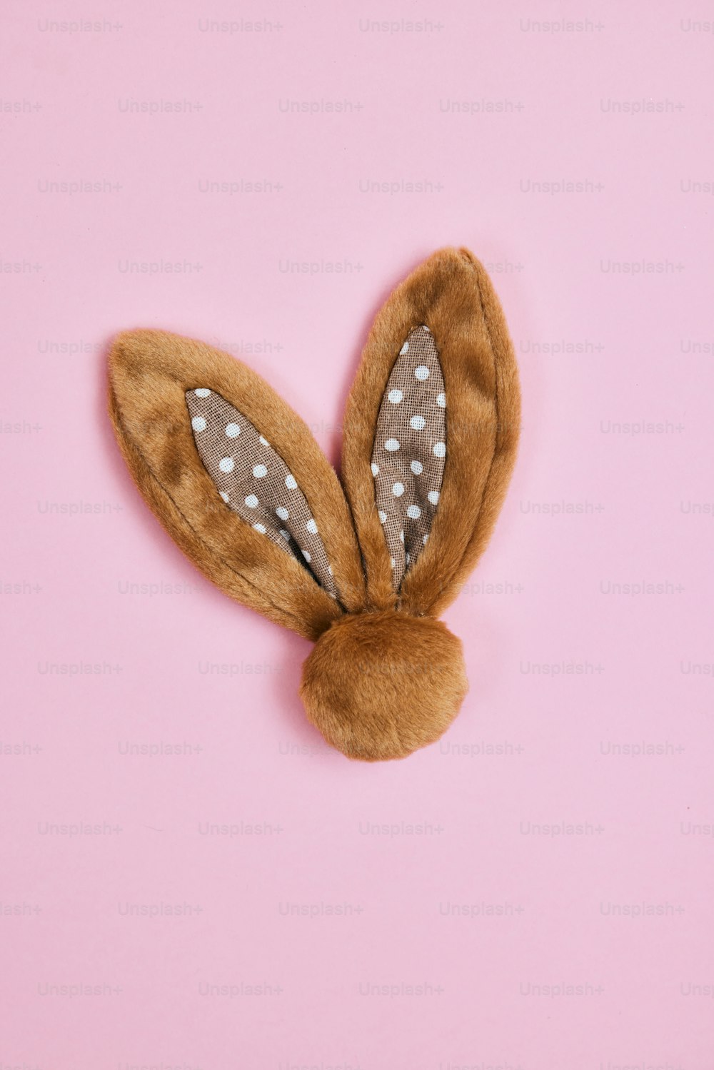 a stuffed animal bunny on a pink background