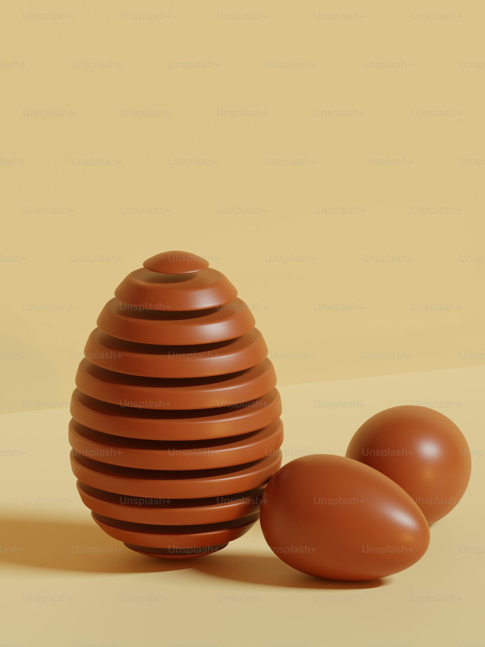 a brown vase sitting next to two brown eggs