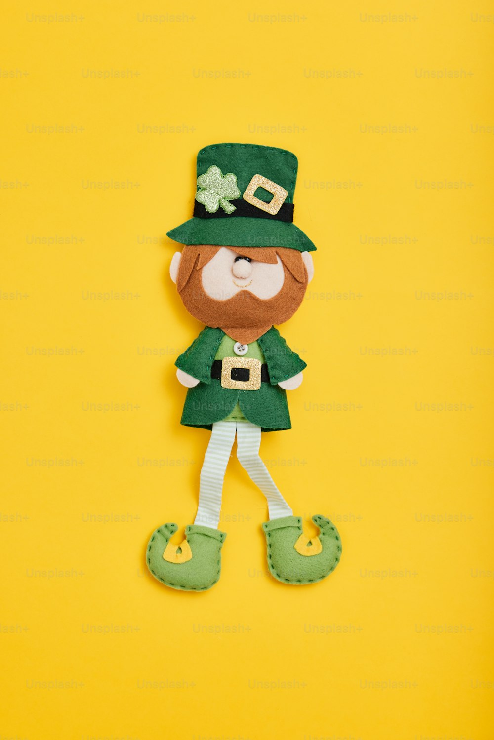 a paper cut out of a lepreite character on a yellow background