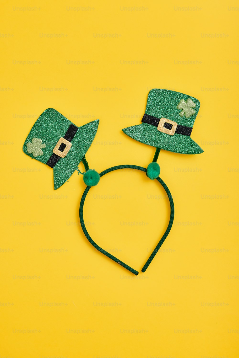a pair of green hats on a yellow background