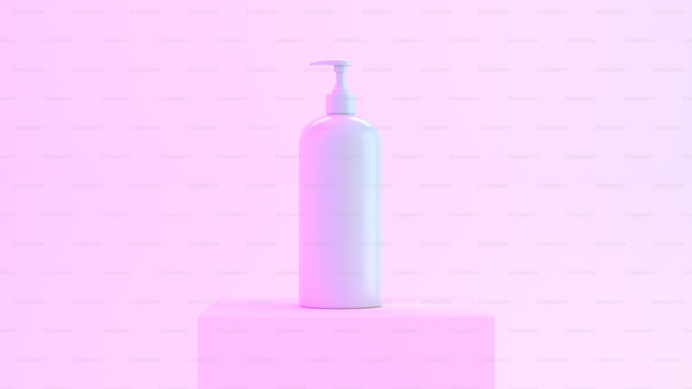 a white bottle sitting on top of a pink block