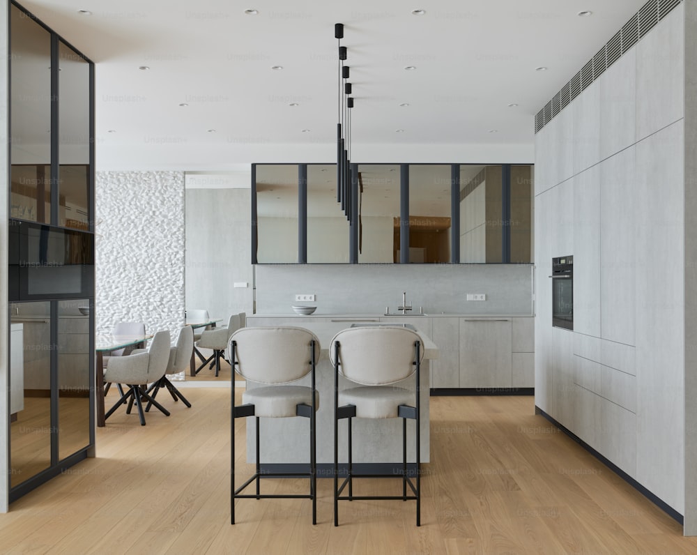 a modern kitchen with a dining table and chairs