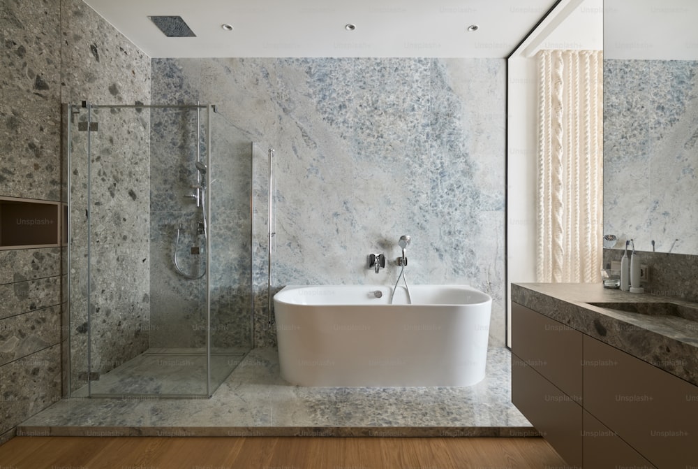 a bathroom with marble walls and a tub