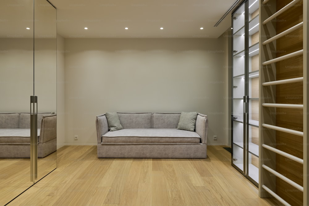 a living room with a couch and a mirror