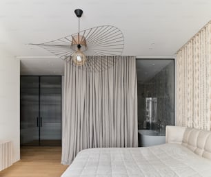 a bedroom with a bed and a chandelier hanging from the ceiling