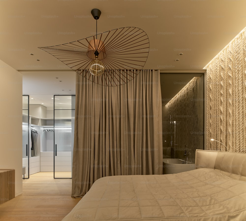a bedroom with a bed and a chandelier hanging from the ceiling