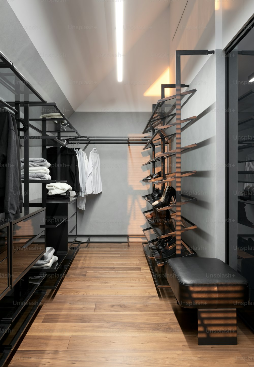 a walk - in closet with wooden floors and shelves