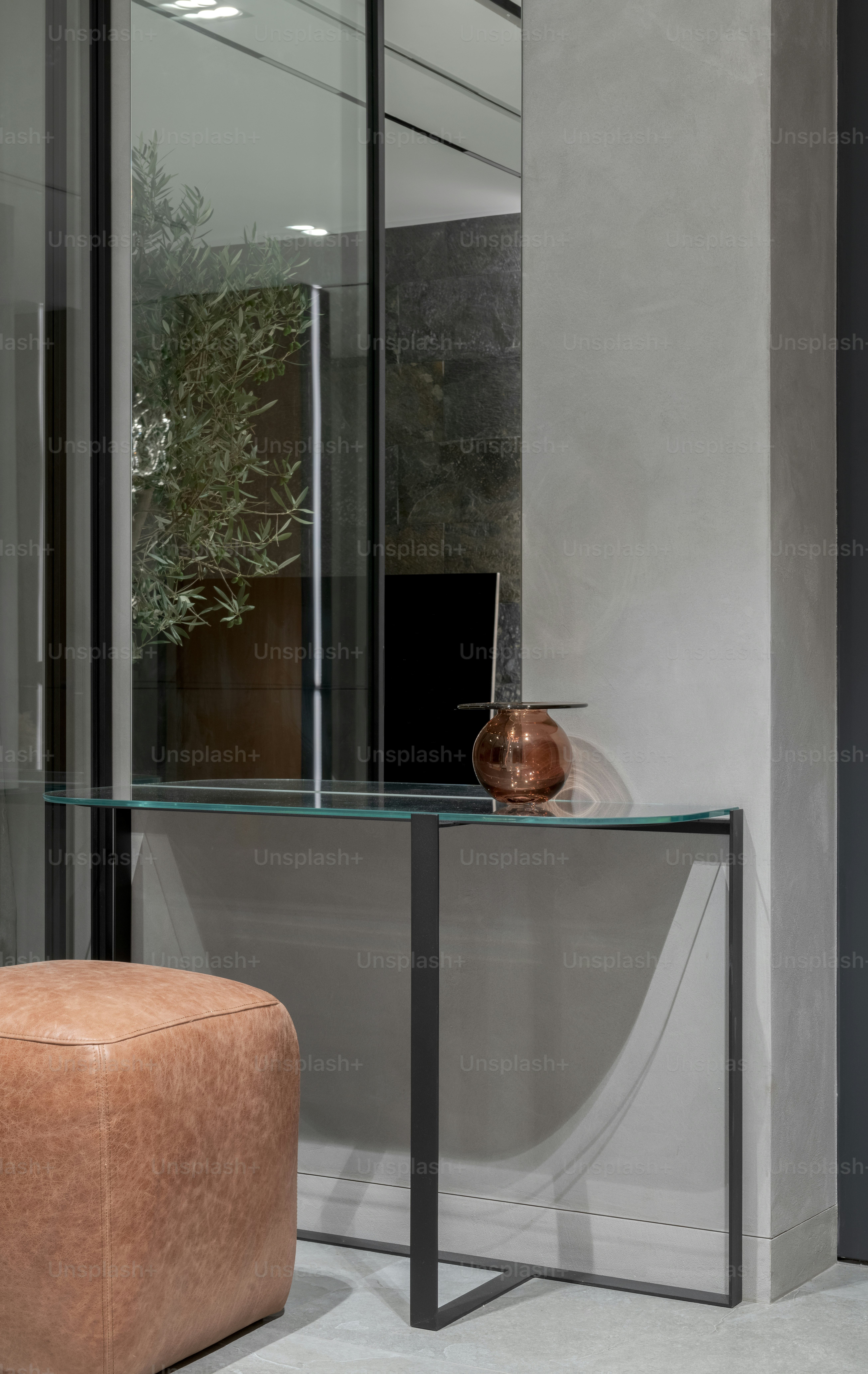 a glass table with a vase on top of it