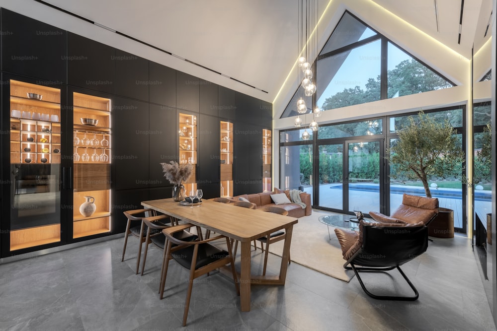 a dining room with a large wooden table surrounded by chairs