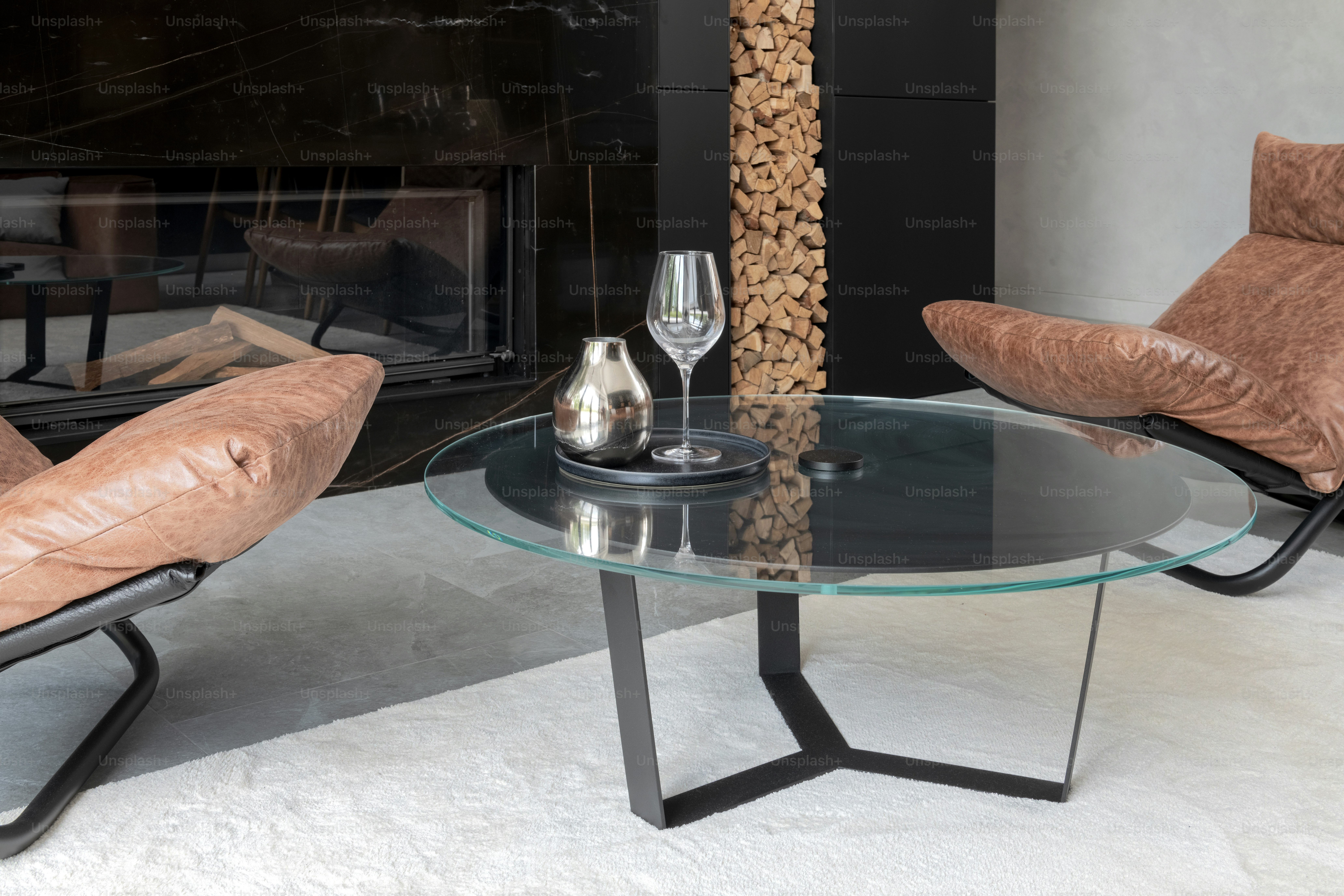 A living room with a glass table and two chairs photo – Living room ...