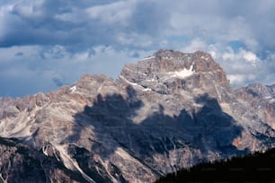 a view of a mountain range with clouds in the sky