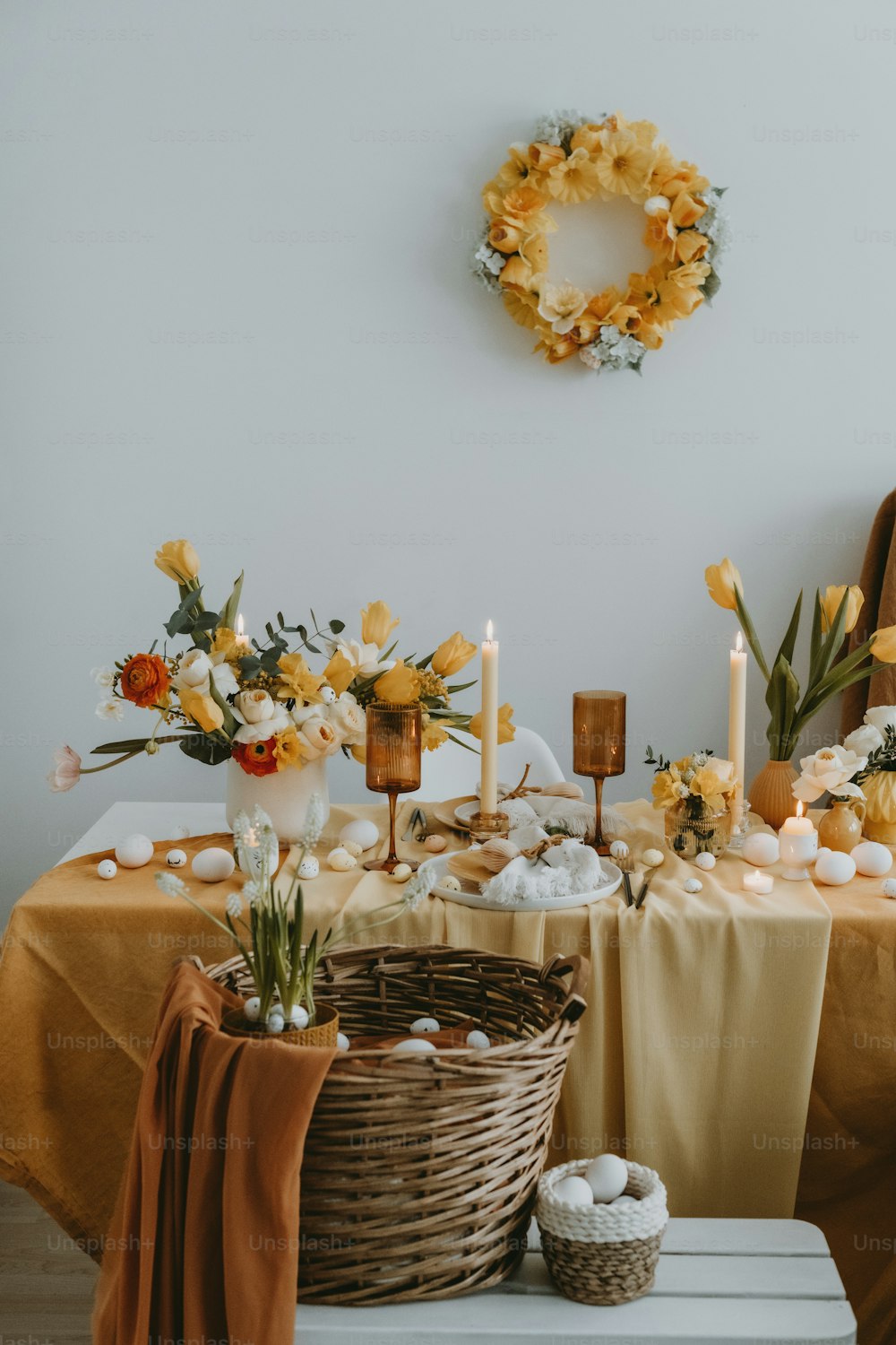 a table topped with a basket filled with flowers