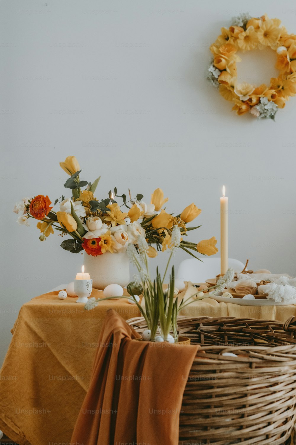 a table topped with a basket filled with flowers