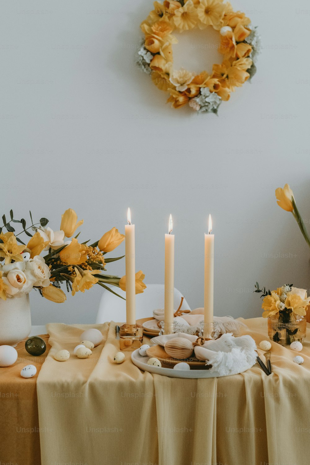 a table topped with a plate of food next to a wreath
