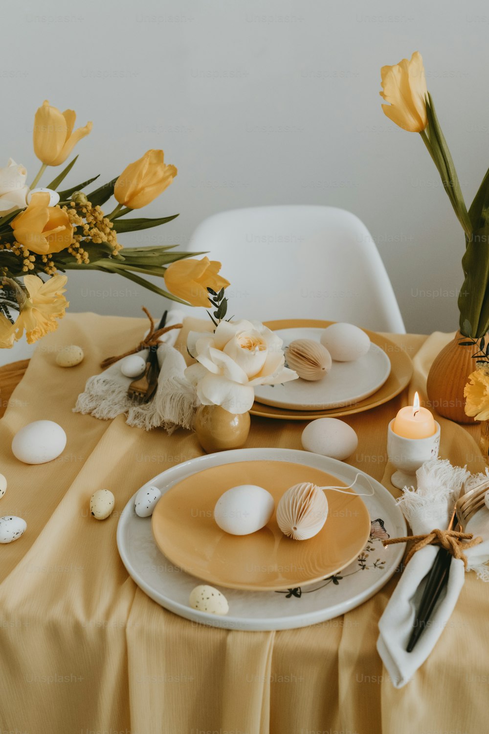ein Tisch mit Tellern und Vasen voller Blumen