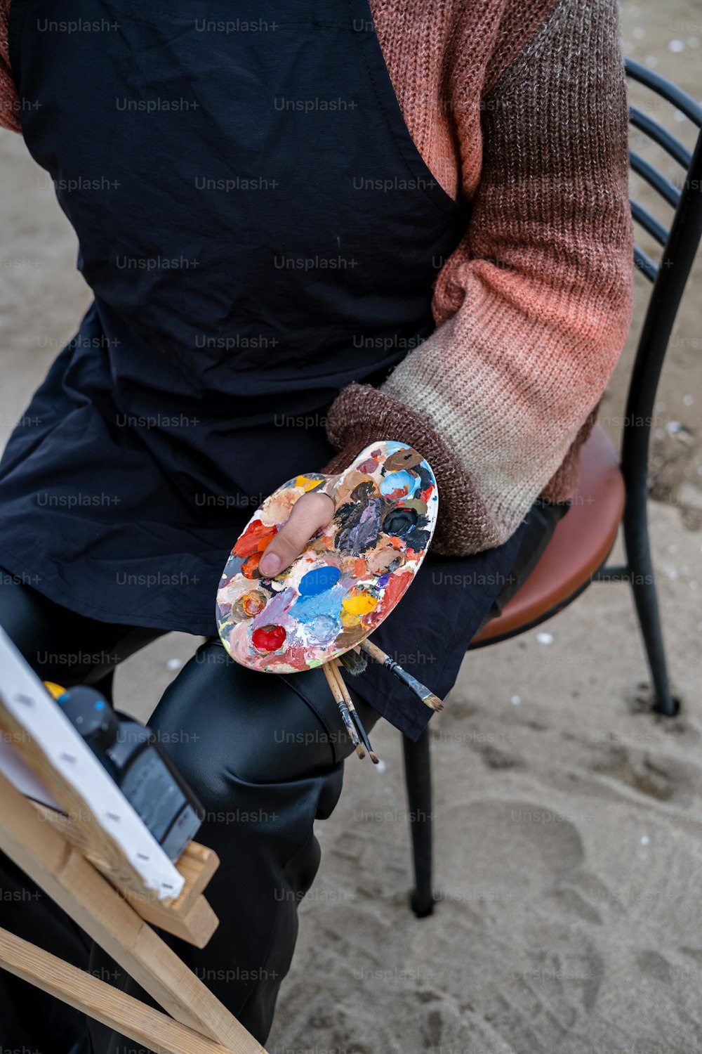 a person holding a plate with a painting on it