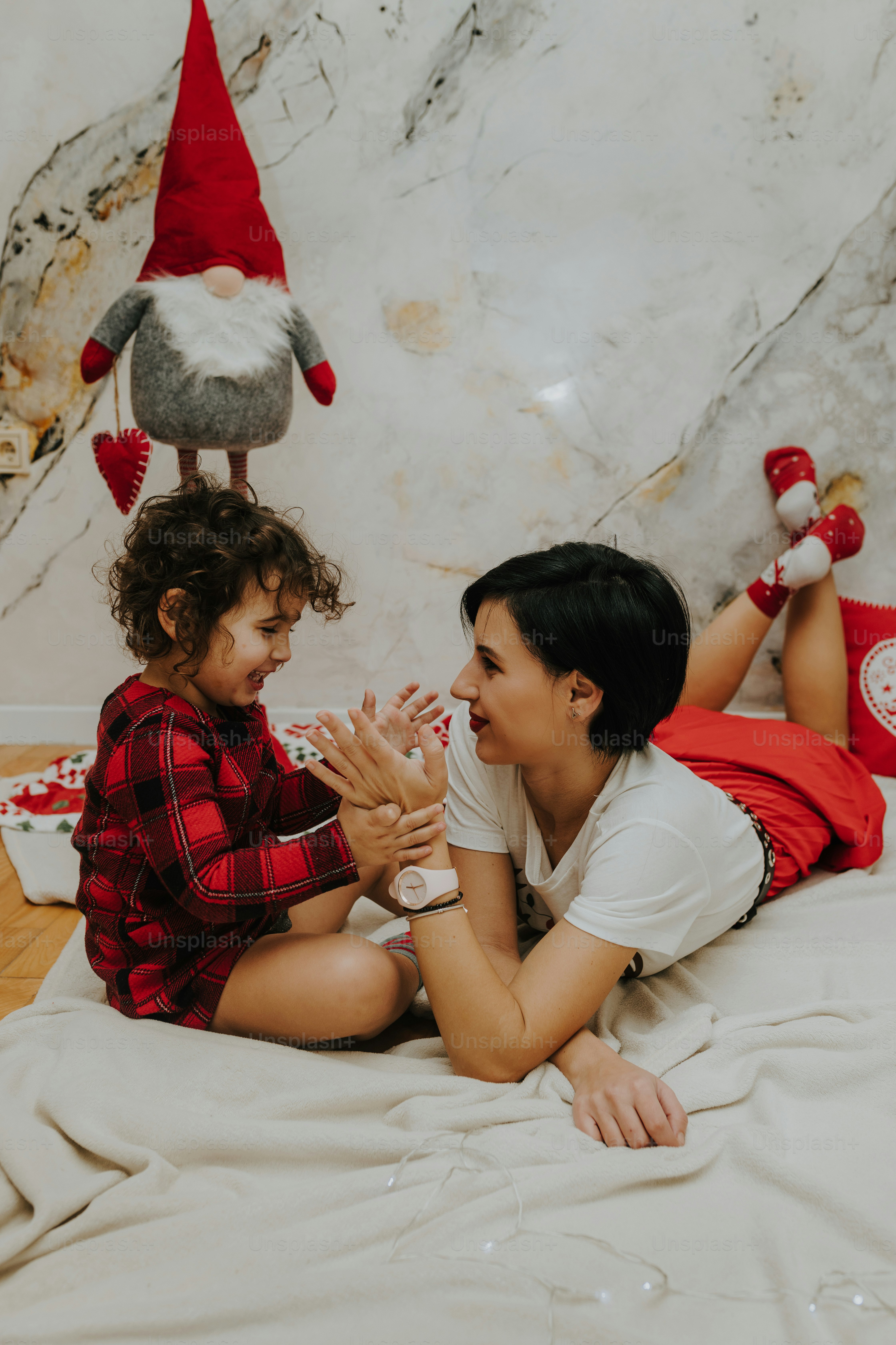 a woman and a child laying on a bed