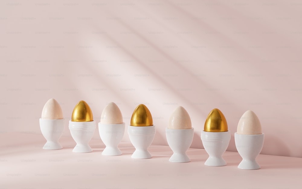 a row of egg cups with golden eggs in them