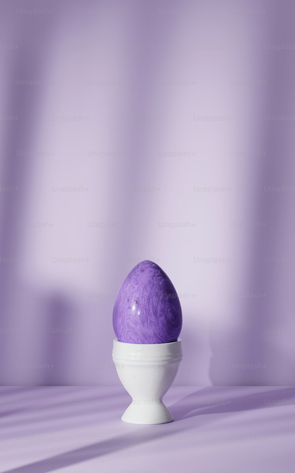 a purple egg sitting in a white bowl