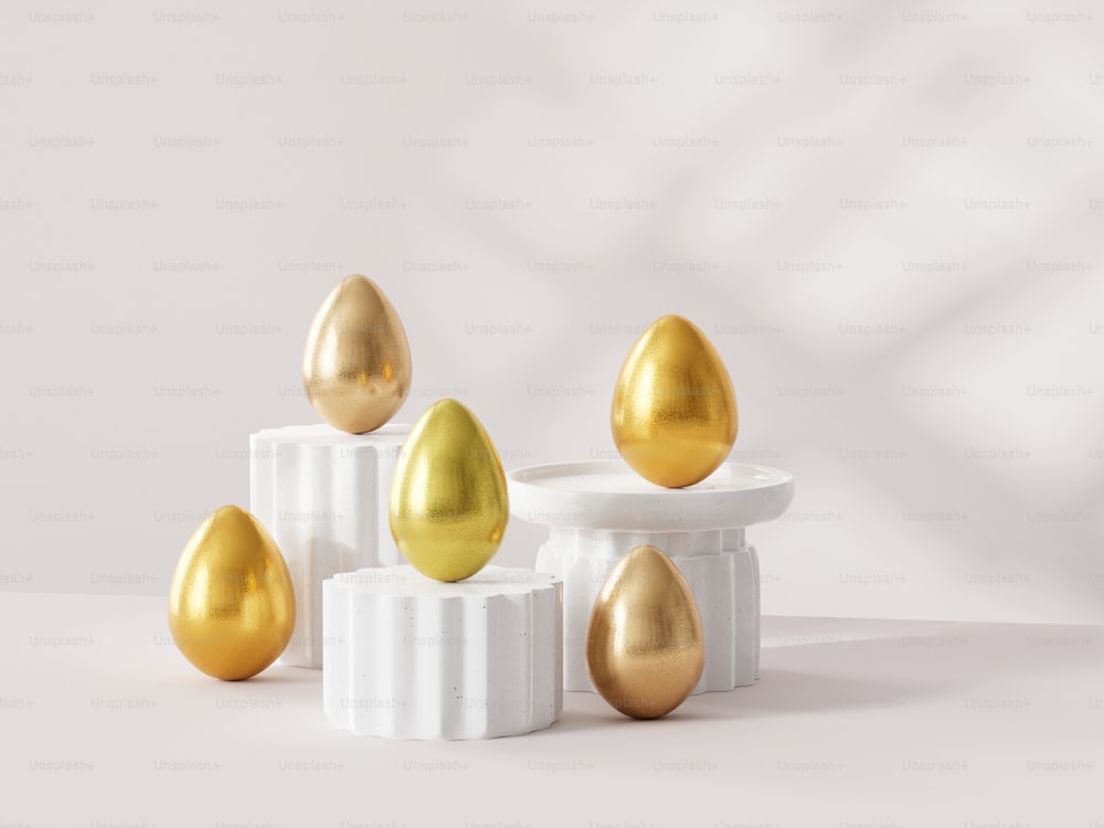 a group of gold and white eggs sitting on top of each other