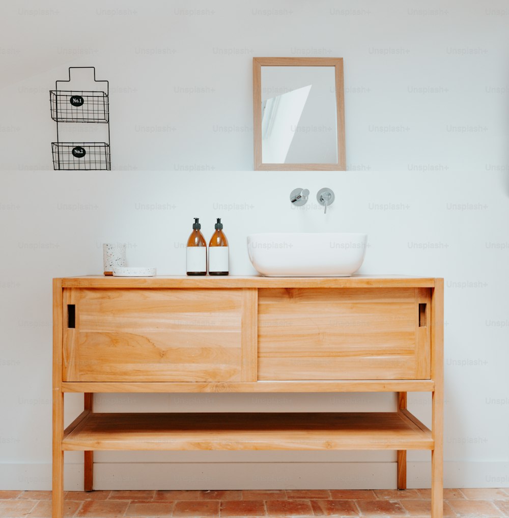 a bathroom with a sink and a wooden cabinet