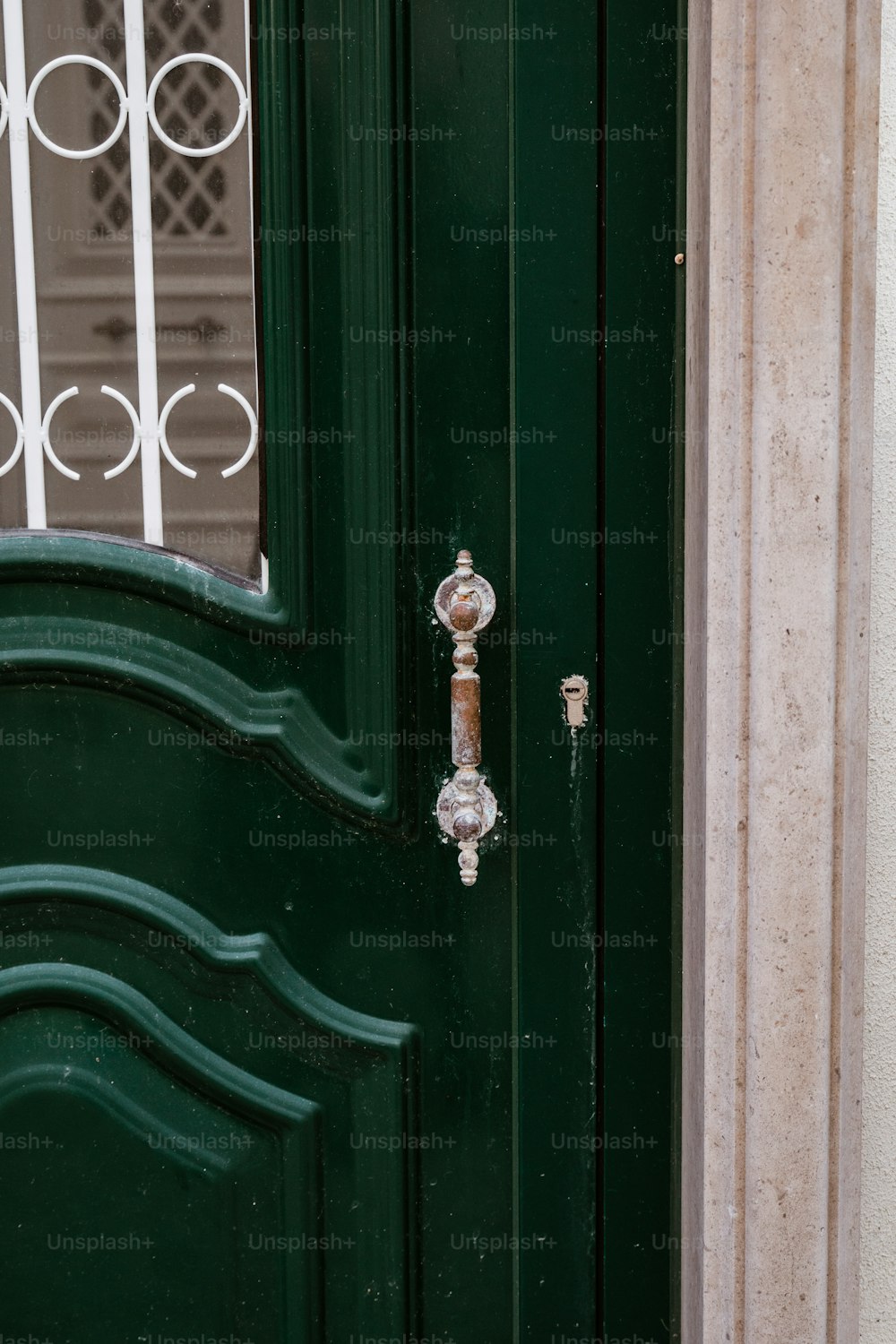 a close up of a green door with a metal handle