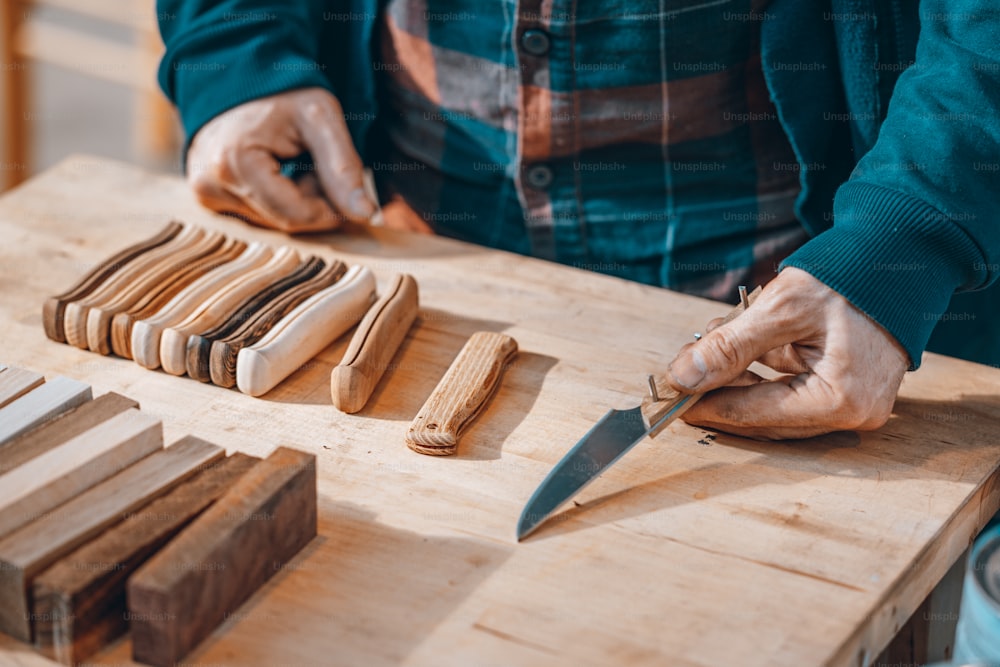 a person with a knife on a cutting board