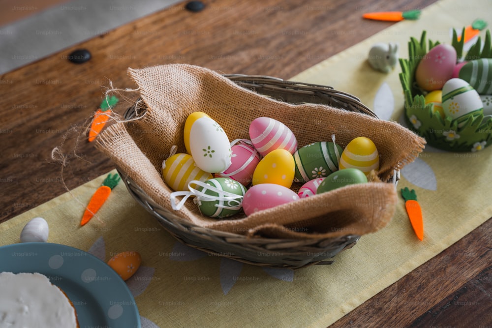 uma cesta de ovos decorados em uma mesa