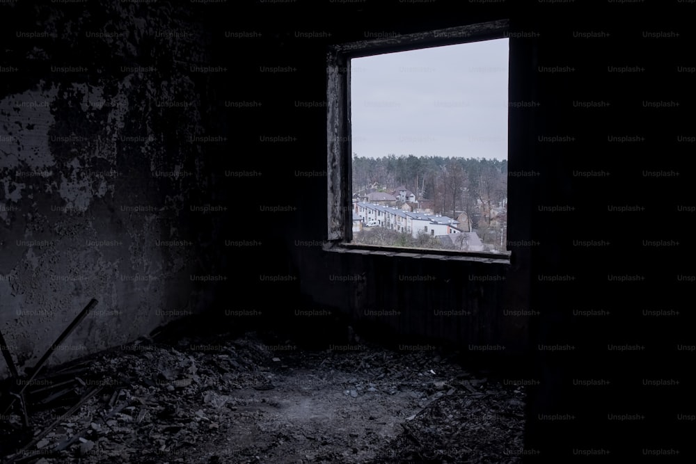 a dark room with a window and a view of a town