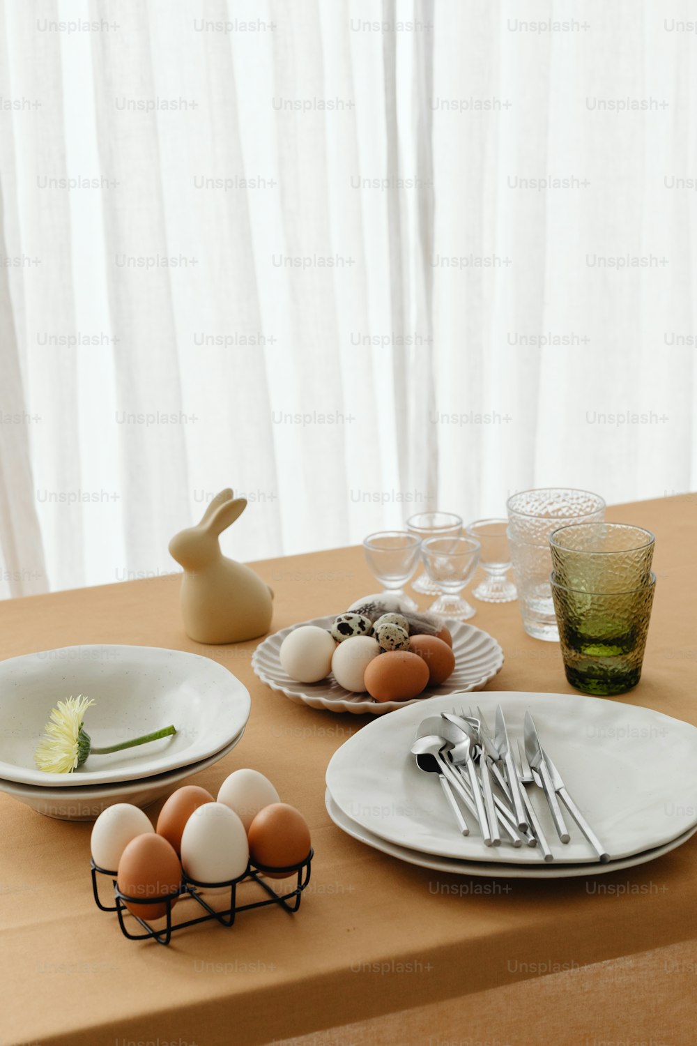 a table topped with plates and bowls filled with eggs