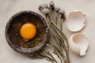 an egg is sitting in a bowl next to eggs
