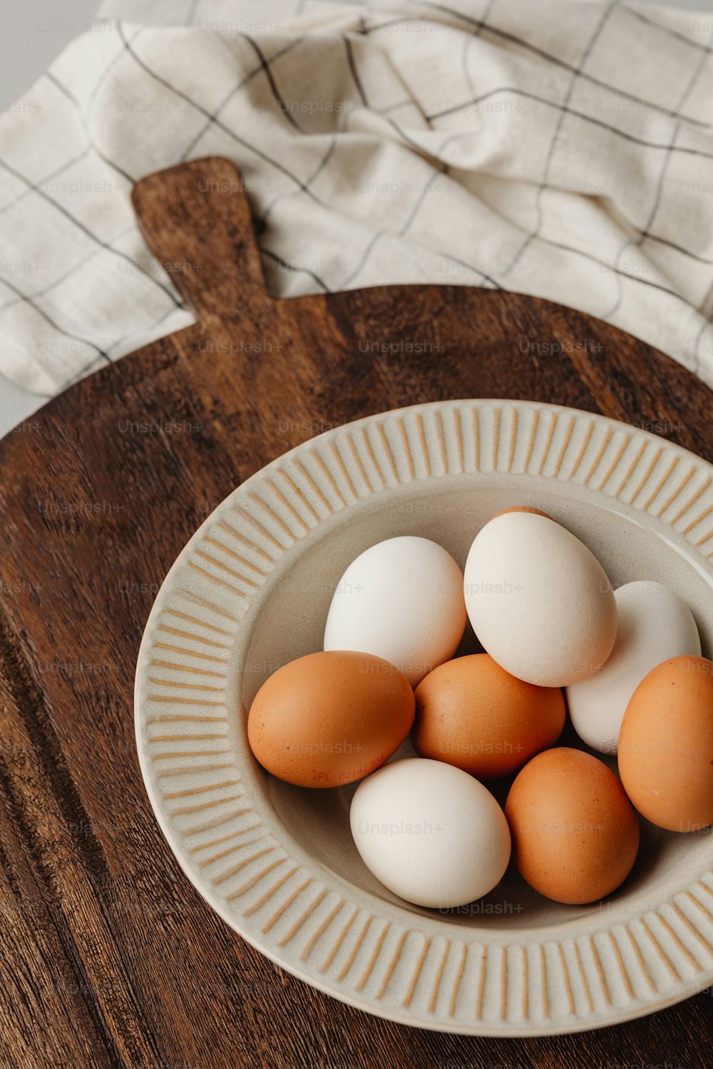 a bowl of eggs sitting on top of a wooden table