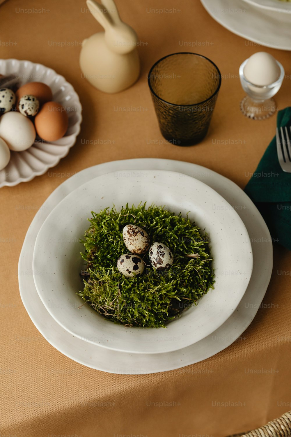 a bowl of moss with eggs in it on a table