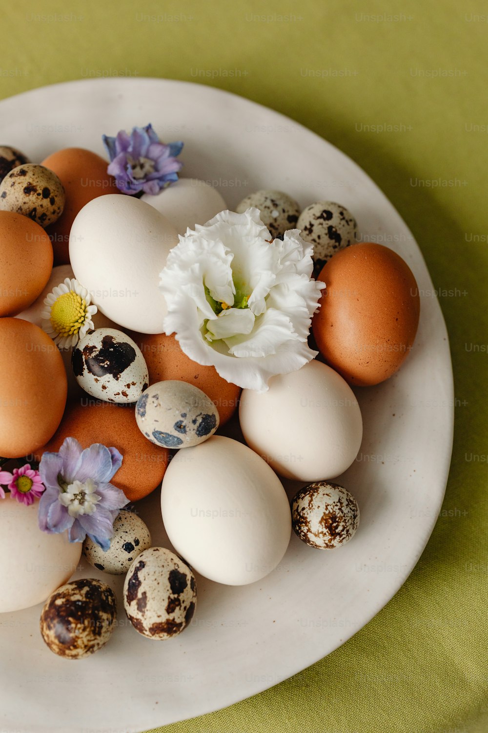 a white plate topped with eggs and quails