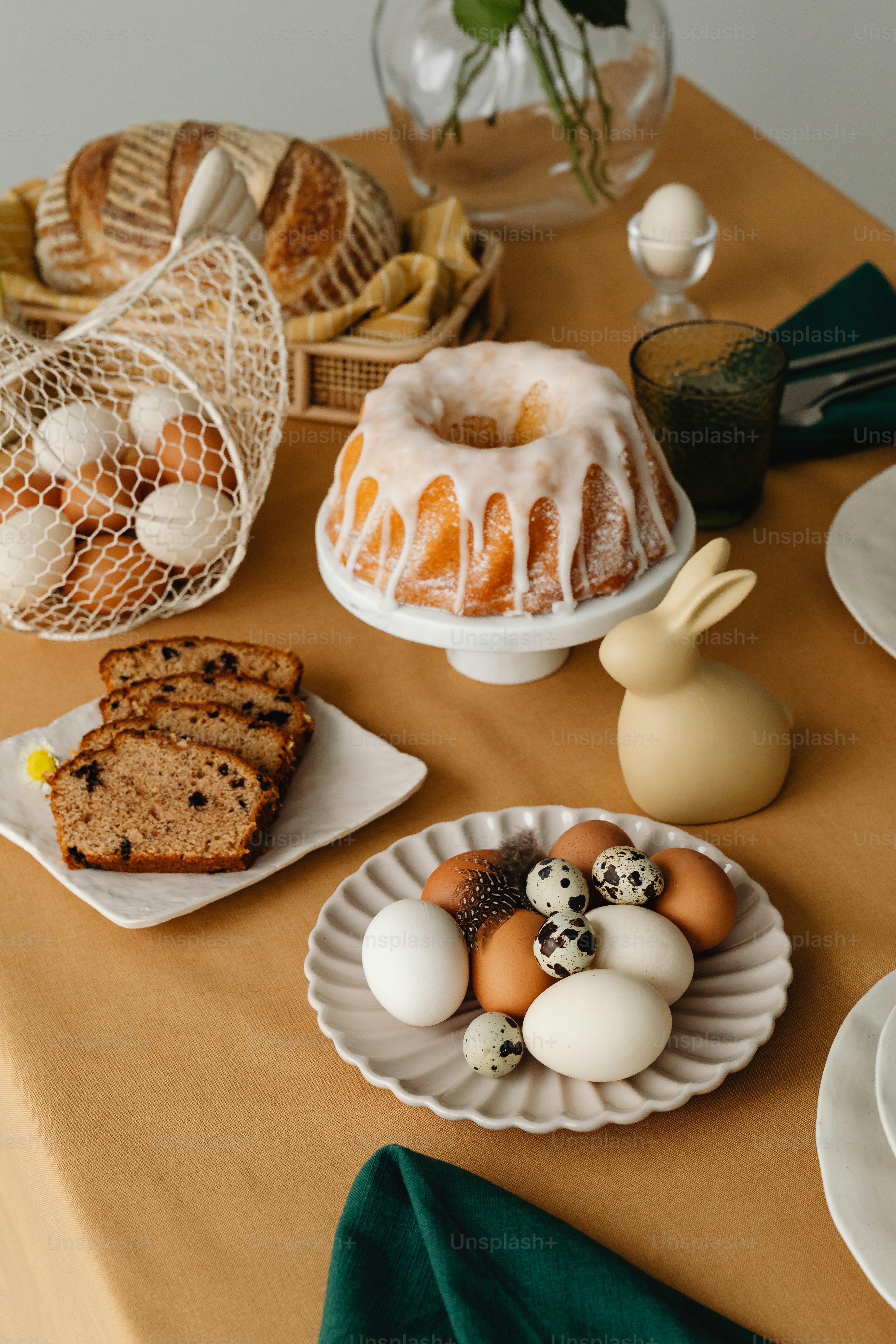 a table topped with plates of food and bundt cakes