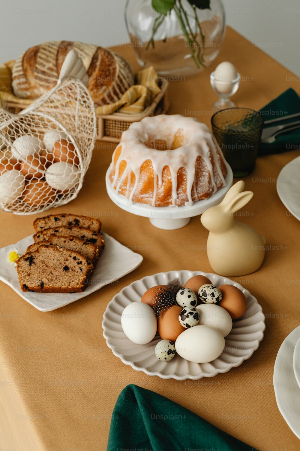 a table topped with plates of food and bundt cakes