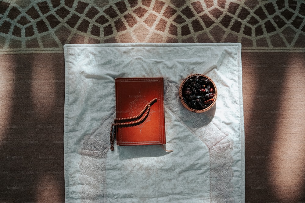 a book and a bowl of food on a towel