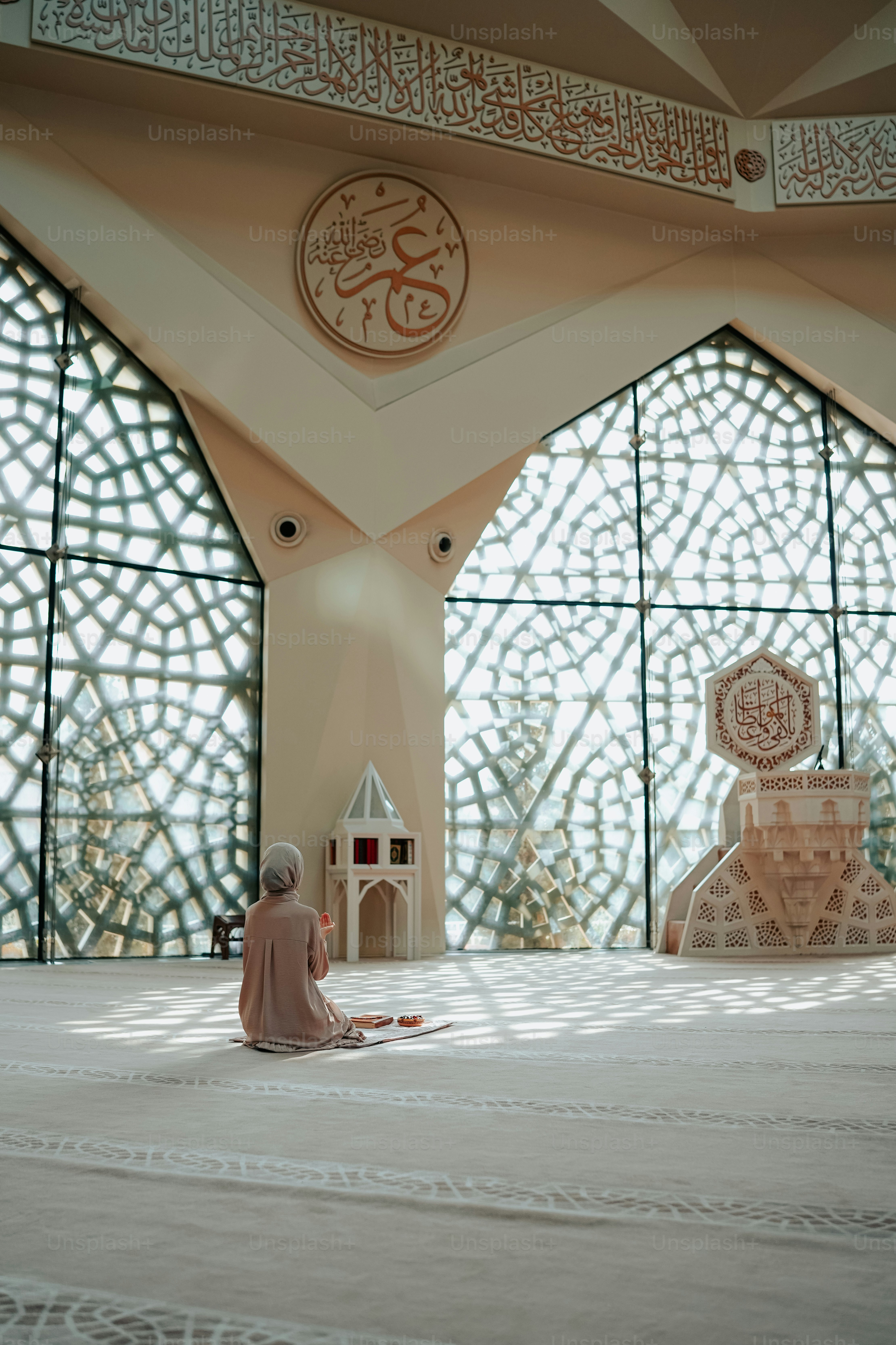 a woman sitting on the floor in front of a large window
