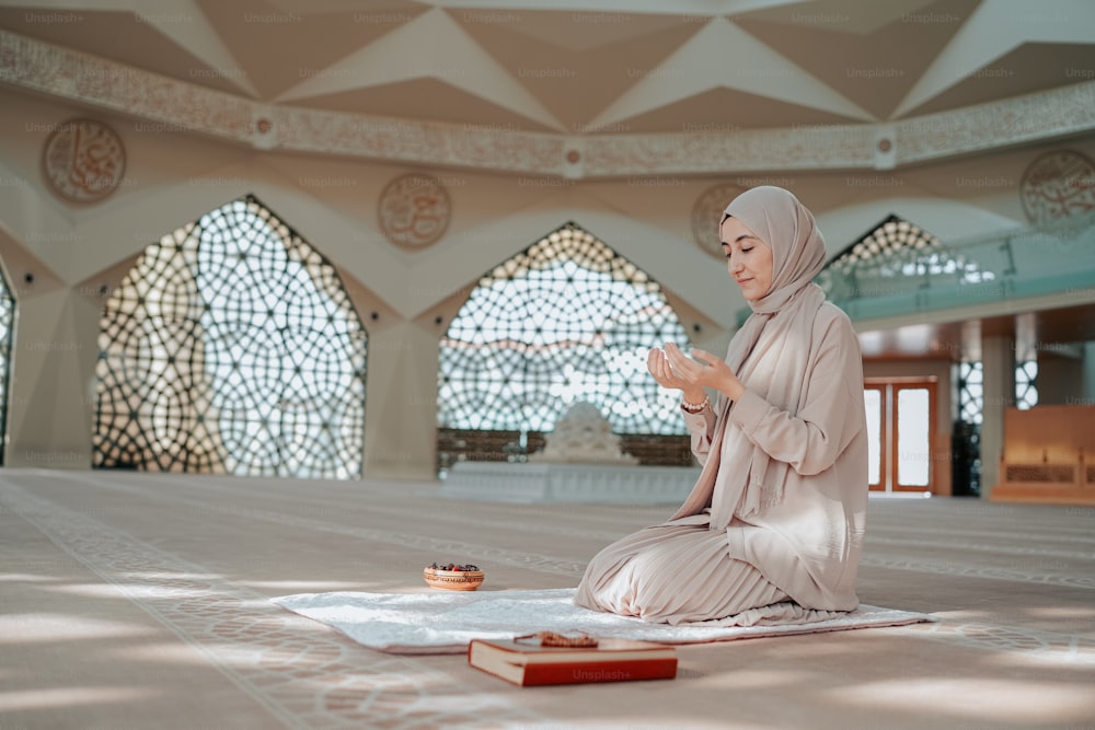 a woman sitting on a rug in a room