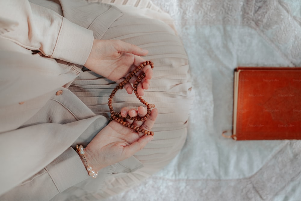 a woman holding a rosary in her hands