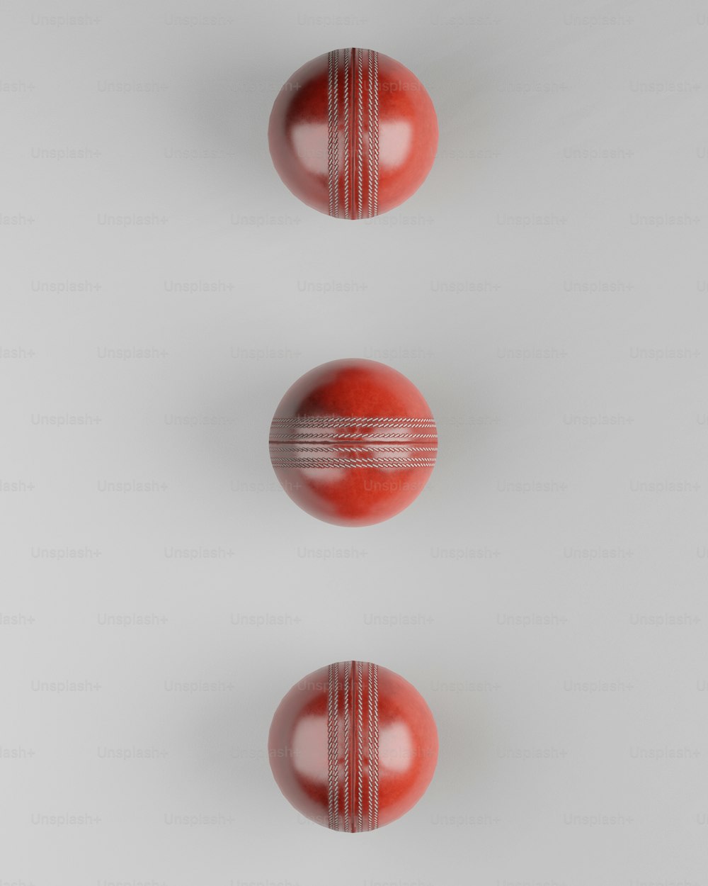 two red bowling balls on a white background