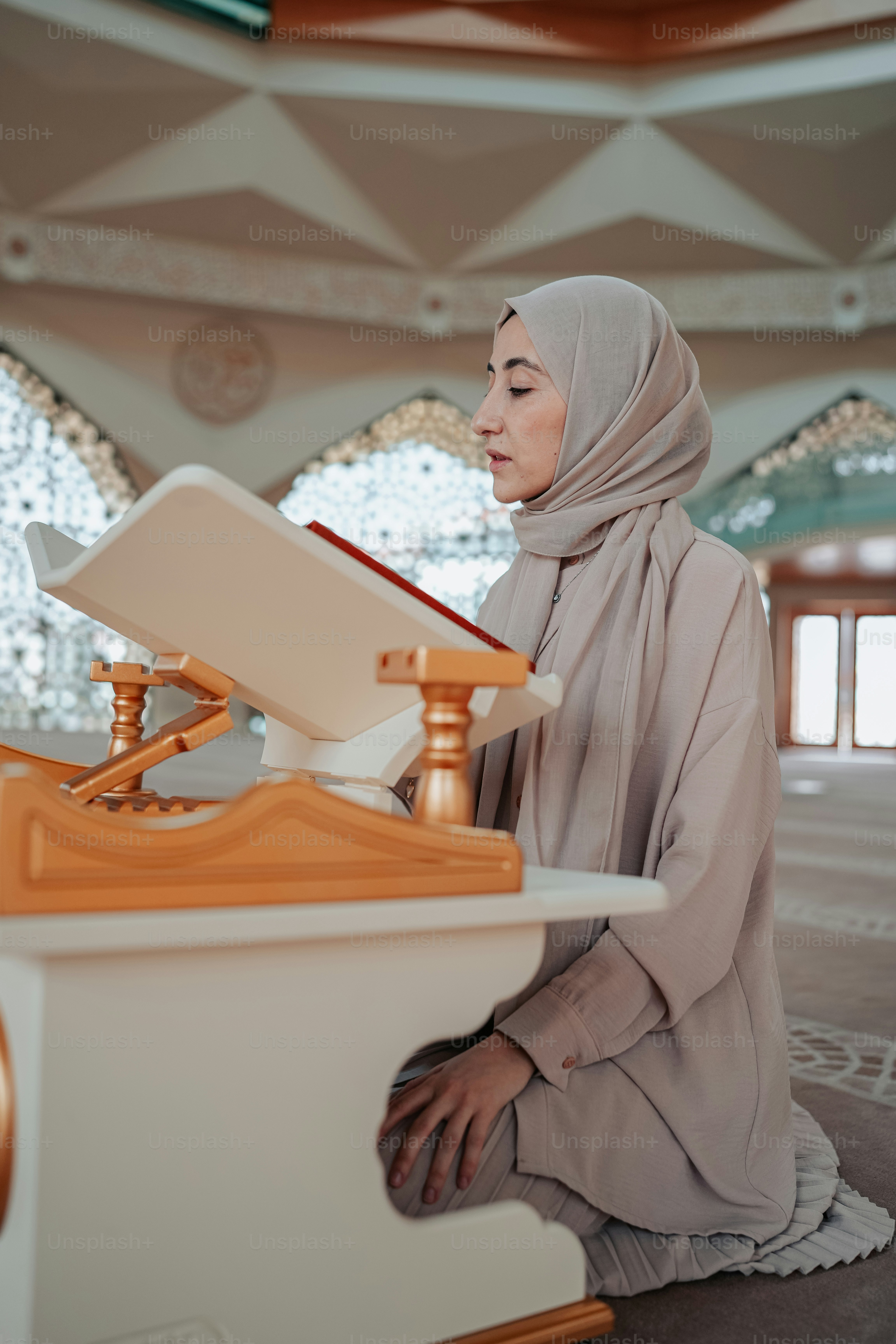 Seorang wanita berjilbab duduk di lantai